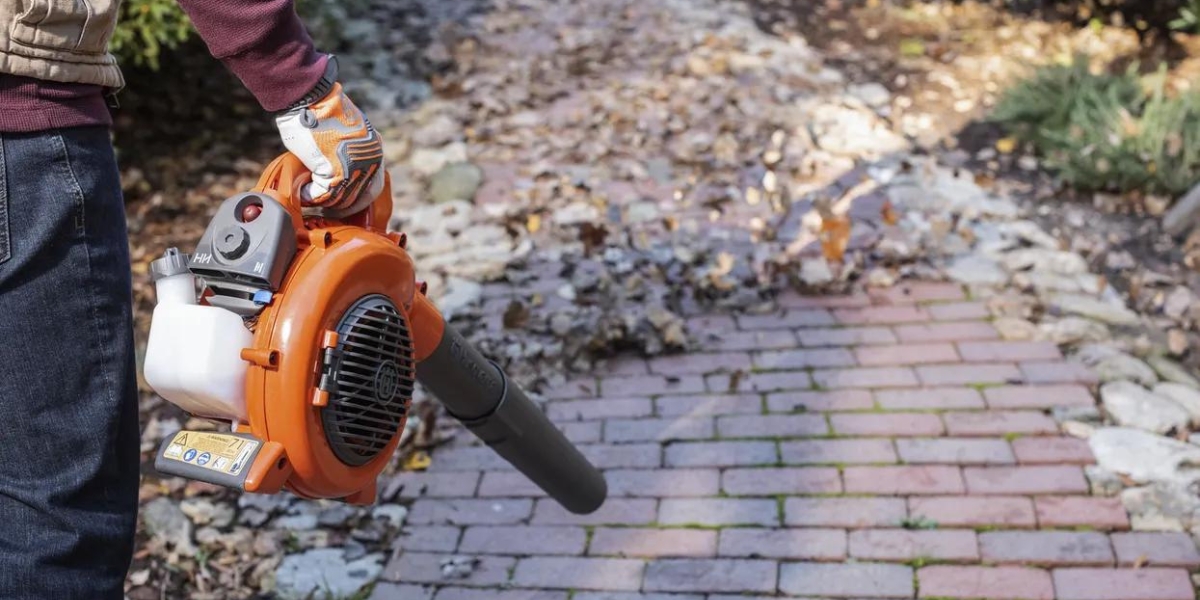 Person using Husqvarna 125B leaf blower