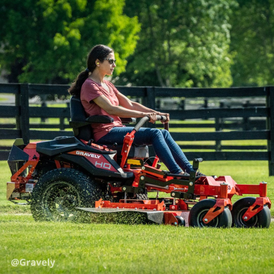 Woman driving Gravely zero-turn mower