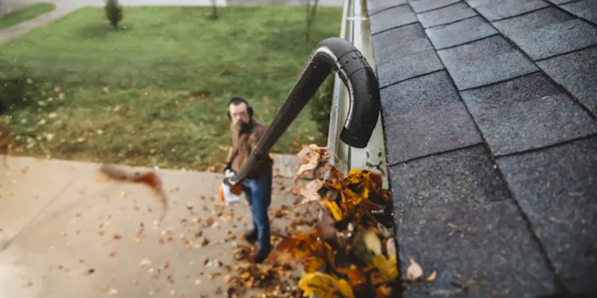 Man cleaning gutters with STIHL gutter kit