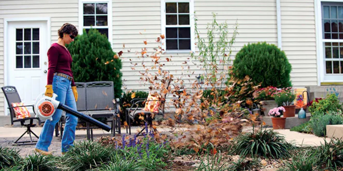 Person blowing leaves with STIHL BG 56 C-E leaf blower